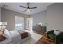 Stylish bedroom with a ceiling fan, hardwood floors, and an outside balcony at 2921 Lenox Ne Rd # 113, Atlanta, GA 30324