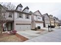 Exterior view of modern townhomes with well-maintained landscaping at 2620 Sardis Chase Court, Buford, GA 30519