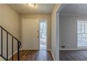 Inviting entryway with hardwood floors, leading to a carpeted living space with ample natural light at 3637 Windmill Rd, Ellenwood, GA 30294