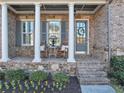 Inviting front porch with stone accents, rocking chairs, and manicured landscaping at 4916 Locklear Way, Marietta, GA 30066