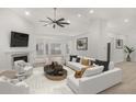 Bright living room boasts high ceilings, fireplace, modern furnishings, and ample natural light at 5180 Sterling Trace Nw Ct, Lilburn, GA 30047