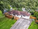 An aerial view of a well-maintained ranch-style house with a spacious wooden deck and landscaped yard at 215 Collum Nw St, Atlanta, GA 30314