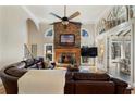 Cozy living room with a stone fireplace, high ceilings, and a comfortable leather sofa at 2160 Bradley Trl, Cumming, GA 30041