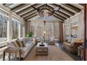 Bright sunroom with vaulted ceiling, large windows, and comfortable seating at 2160 Bradley Trl, Cumming, GA 30041
