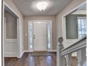 Bright foyer with hardwood floors, decorative door, and a staircase at 3253 Brookshire Way, Duluth, GA 30096