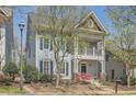 Charming two-story home with a welcoming front porch and beautifully landscaped front yard under mature trees at 489 Carter Se Ave, Atlanta, GA 30317