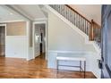 Elegant foyer featuring hardwood floors, wainscoting, and a staircase with iron spindles at 489 Carter Se Ave, Atlanta, GA 30317