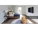 A cozy bedroom featuring a comfortable bed, stylish decor, and access to a private balcony at 1941 Brian Way # 1941, Decatur, GA 30033