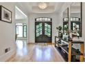 Bright foyer with wood floors, black framed glass doors, stylish console table, and elegant chandelier at 237 Webney Se Dr, Marietta, GA 30068