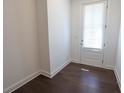 Bright entryway with dark hardwood flooring and a door with window and blinds at 6569 Beacon Dr, Sandy Springs, GA 30328