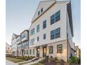 Attractive townhome row with light exterior, brick foundations, and manicured landscaping at 6569 Beacon Dr, Sandy Springs, GA 30328