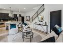 Open-concept space with modern furnishings, sleek black staircase, and stylish decor at 1792 Charles Nw Pl, Atlanta, GA 30318
