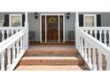 Inviting front porch with brick steps, a decorative door with wreath and a seating area for relaxation at 4720 Timberland Sw Dr, Mableton, GA 30126