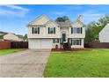 Traditional two-story home featuring a two-car garage, well-manicured lawn, and inviting entryway at 522 Bass Nw Pointe, Kennesaw, GA 30144