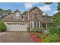 Beautiful two-story home with stone facade, bay window, and landscaped front yard at 962 Cove Lake Ct, Lawrenceville, GA 30045
