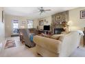 Cozy living room features a stone fireplace, comfortable seating, and a ceiling fan at 962 Cove Lake Ct, Lawrenceville, GA 30045