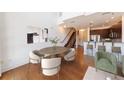 Open dining area boasts hardwood floors, modern chairs, and seamless flow into the kitchen and staircase at 1221 Caroline Ne St # 201, Atlanta, GA 30307