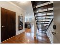 Entryway featuring hardwood floors, an open staircase, and a partial view of the kitchen and dining area at 1221 Caroline Ne St # 201, Atlanta, GA 30307