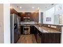 Well-equipped kitchen boasts stainless steel appliances, granite countertops, and dark wood cabinets at 1221 Caroline Ne St # 201, Atlanta, GA 30307