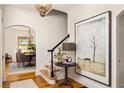 Grand foyer with hardwood floors, staircase, stylish light fixture and artwork at 950 Clairemont Ave, Decatur, GA 30030