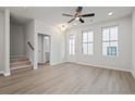 Bright living room with stairs, plank floors, and a door to the outside at 58 Black Gum Ln # 47, Auburn, GA 30011