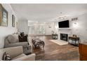 Spacious living room with hardwood floors, a fireplace, neutral-toned furniture, and large shuttered windows at 3203 Lenox Ne Rd # 3, Atlanta, GA 30324