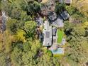Aerial view of a luxury home with a pool, lush greenery, and stone patio at 3540 Tuxedo Nw Rd, Atlanta, GA 30305
