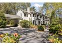 Elegant home featuring a covered driveway, beautiful landscaping, and a well-maintained exterior at 3540 Tuxedo Nw Rd, Atlanta, GA 30305