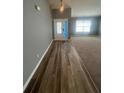 Inviting entryway featuring wood-look tile flooring, a decorative chandelier, and an open view to the living area at 8236 Eastshore Dr, Union City, GA 30291