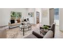 Sun-drenched living room featuring neutral tones, contemporary furnishings, and ample natural light at 1800 Charles Nw Pl, Atlanta, GA 30318