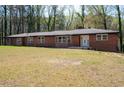 Charming red brick home with a well-manicured lawn and a classic design at 3042 Peek Nw Rd, Atlanta, GA 30318