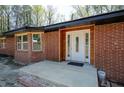 Close-up view of the brick home's entrance featuring a white door with decorative glass at 3042 Peek Nw Rd, Atlanta, GA 30318