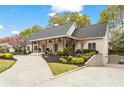 Charming home featuring a covered front porch, manicured landscaping, and convenient driveway access at 417 Lynne Cir, Alpharetta, GA 30009