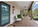 Inviting covered front porch with comfortable seating, a glass front door, and elegant outdoor lighting at 417 Lynne Cir, Alpharetta, GA 30009