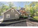 Attractive house with a welcoming front porch, complemented by lush landscaping and a beautiful tree in the front yard at 608 Apache Trl, Woodstock, GA 30189