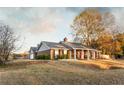 Beautiful single-story home with a well-manicured lawn, attached garage, and brick exterior at 3874 Carriage Sw Ln, Conyers, GA 30094