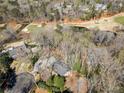 Wide aerial view of the brick home and the surrounding neighborhood, golf course, and lake area at 812 Burning Tree Se Ct, Marietta, GA 30067