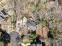 Overhead view of the home's roof, circular driveway, and surrounding trees, with other houses nearby at 812 Burning Tree Se Ct, Marietta, GA 30067