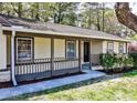 Lovely ranch-style home boasts a covered front porch, detailed railing, and neat landscaping at 3427 Springlake Dr, Decatur, GA 30032
