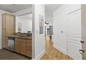 Hallway view from kitchen leading to open and airy living space, bright natural light, and clean white walls at 799 Hammond Dr # 205, Sandy Springs, GA 30328