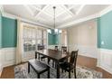 Bright dining area featuring a coffered ceiling, window views, and classic decor at 2145 Red Barn Ct, Cumming, GA 30040