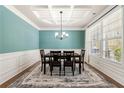 Elegant dining room with coffered ceiling, large window, and stylish table setting at 2145 Red Barn Ct, Cumming, GA 30040