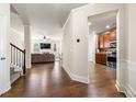 Inviting hallway with hardwood floors, leading to a spacious living room and modern kitchen at 2145 Red Barn Ct, Cumming, GA 30040
