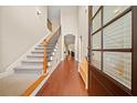 Elegant foyer with hardwood floors, high ceilings, and stairway with iron balusters at 3124 Bentgrass Ln, Kennesaw, GA 30144