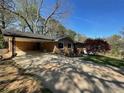 Well-maintained brick home with a paved driveway and an attached carport providing covered parking at 445 Royal Oaks Ter, Stone Mountain, GA 30087