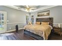 Comfortable bedroom with hardwood floors, a large window, and a rustic headboard at 5163 Holly Springs Dr, Douglasville, GA 30135