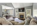 Bright living room features a cozy fireplace, comfortable seating, and ample natural light at 5163 Holly Springs Dr, Douglasville, GA 30135