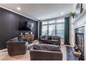 Inviting living room with stylish seating, fireplace, and large windows for natural light at 240 Renaissance Ne Pkwy # 106, Atlanta, GA 30308