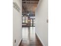 Hallway leading to living area with hardwood floors and industrial ceiling at 3235 Roswell Ne Rd # 421, Atlanta, GA 30305