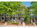 Charming townhomes with brick accents, stairs, and lush green trees at 1112 Park S Row, Atlanta, GA 30312